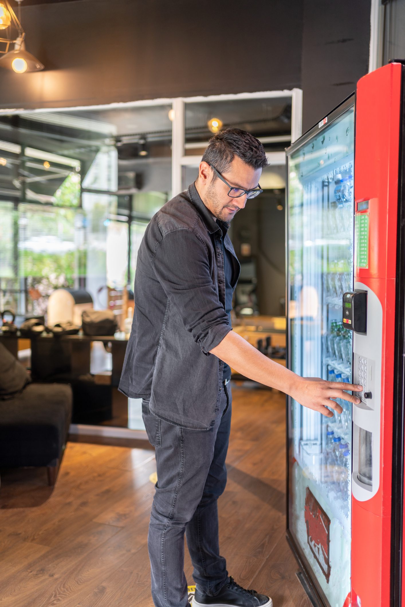Man using vending machine in office