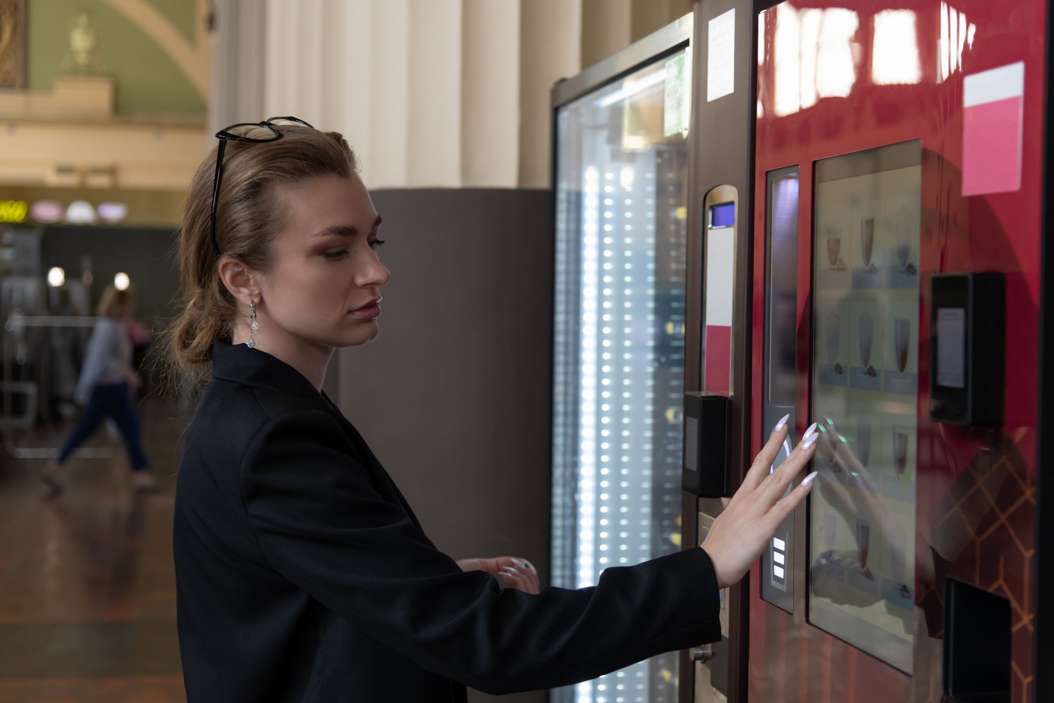 Woman selecting item from vending machine